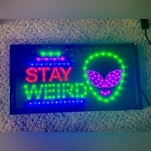 LED Alien Stay Weird sign, blinking lights.